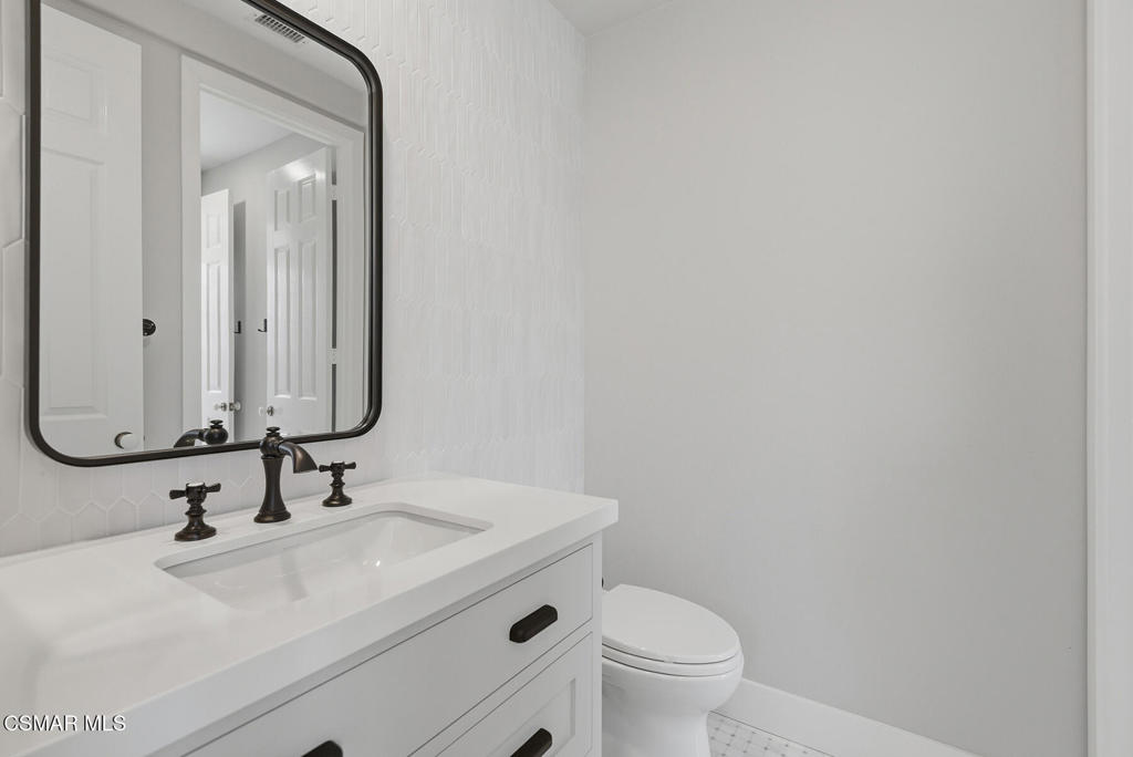4630 Rio Bravo Court Moorpark, CA 93021 - Photo 35 of 43 a bathroom with a sink a toilet and mirror
