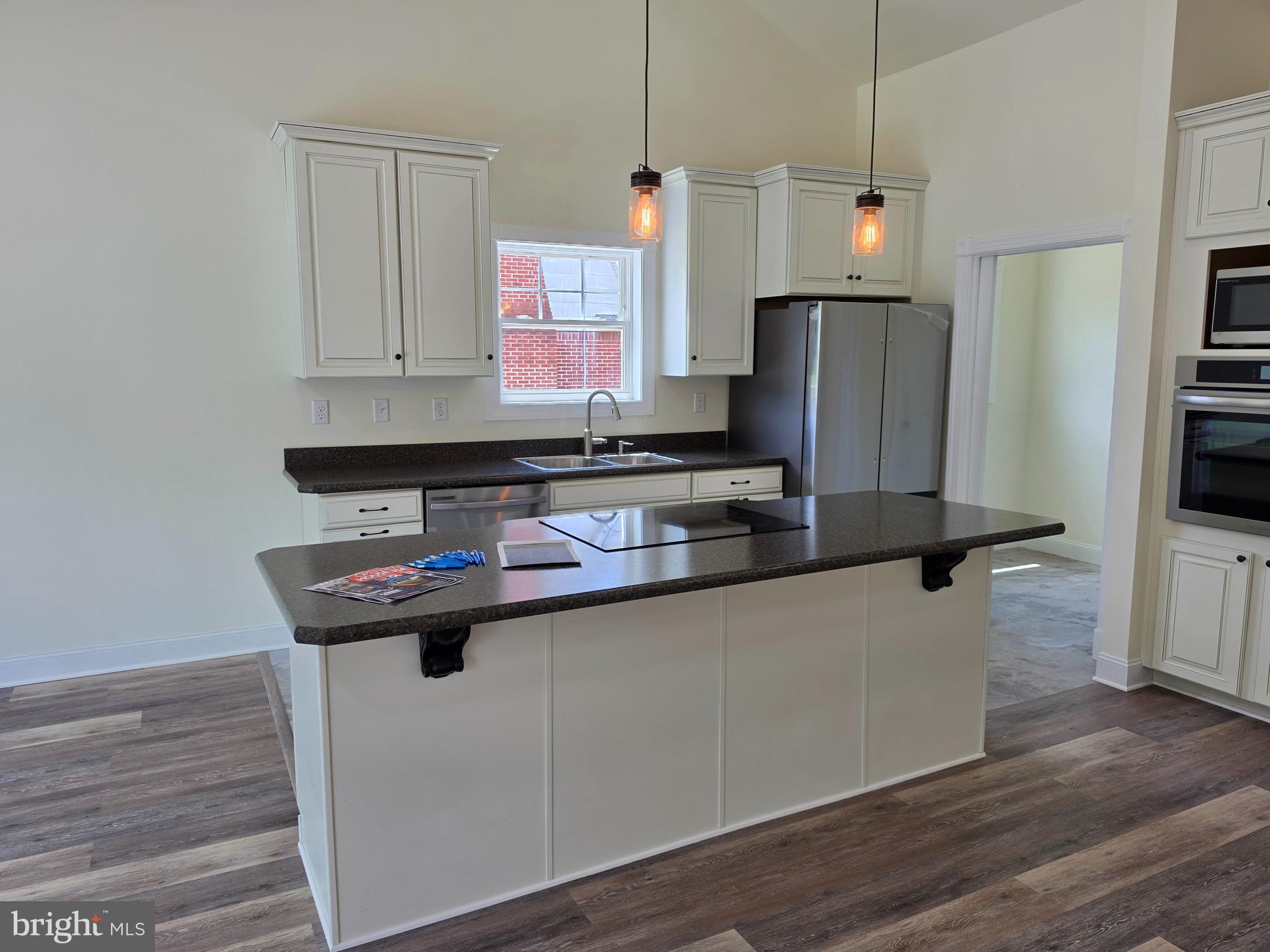 13514 Old Cresaptown Road Southwest Lavale, MD 21502 - Photo 7 of 25 a kitchen with stainless steel appliances granite countertop a sink a stove and a refrigerator