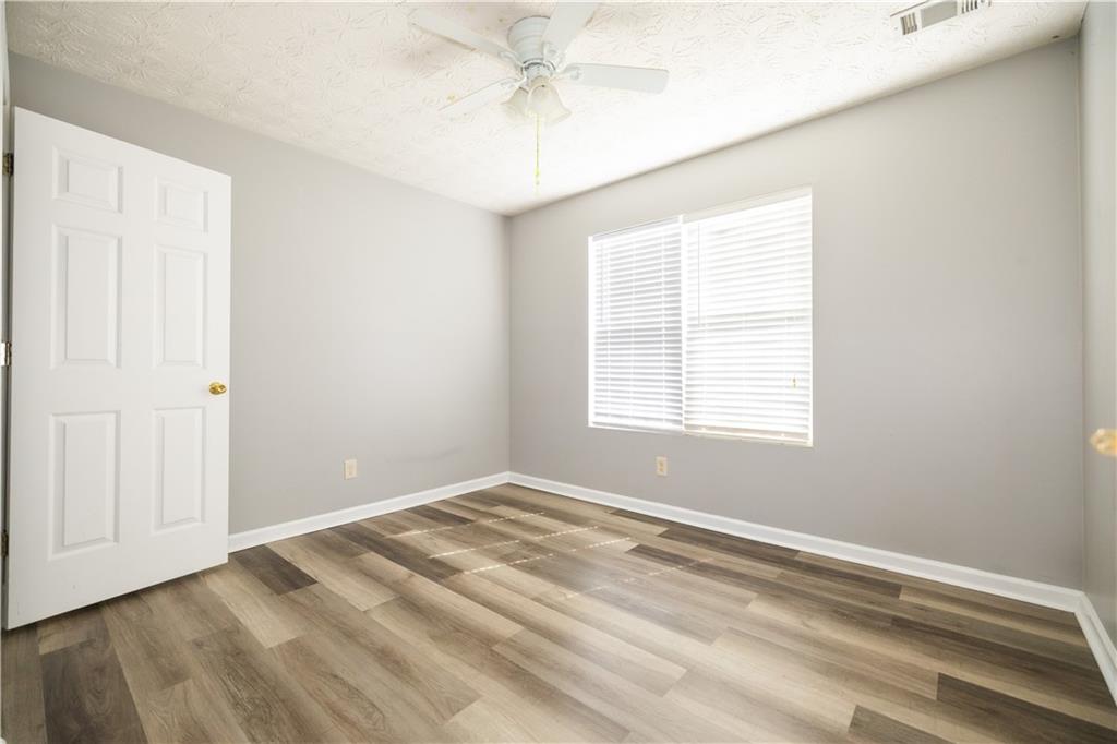 599 Rivulett Court Lawrenceville, GA 30043 - Photo 17 of 31 a view of a room with a ceiling fan and a window