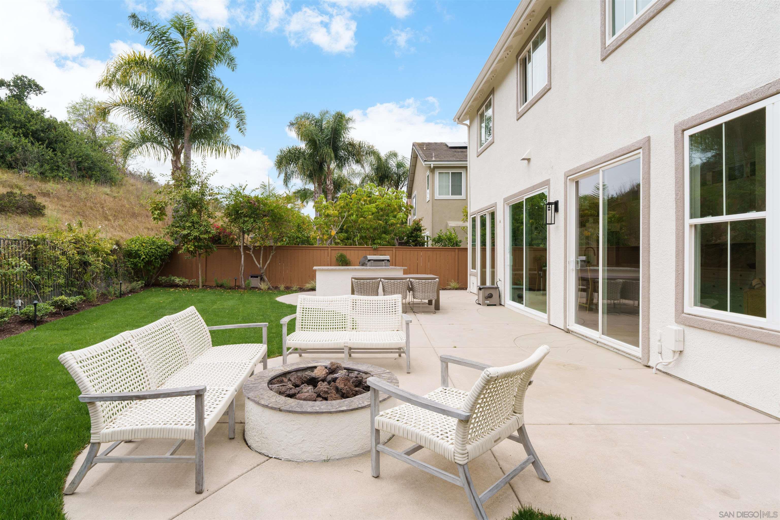 5077 Ashberry Road Carlsbad, CA 92008 - Photo 15 of 35 a patio view with a garden and outdoor seating