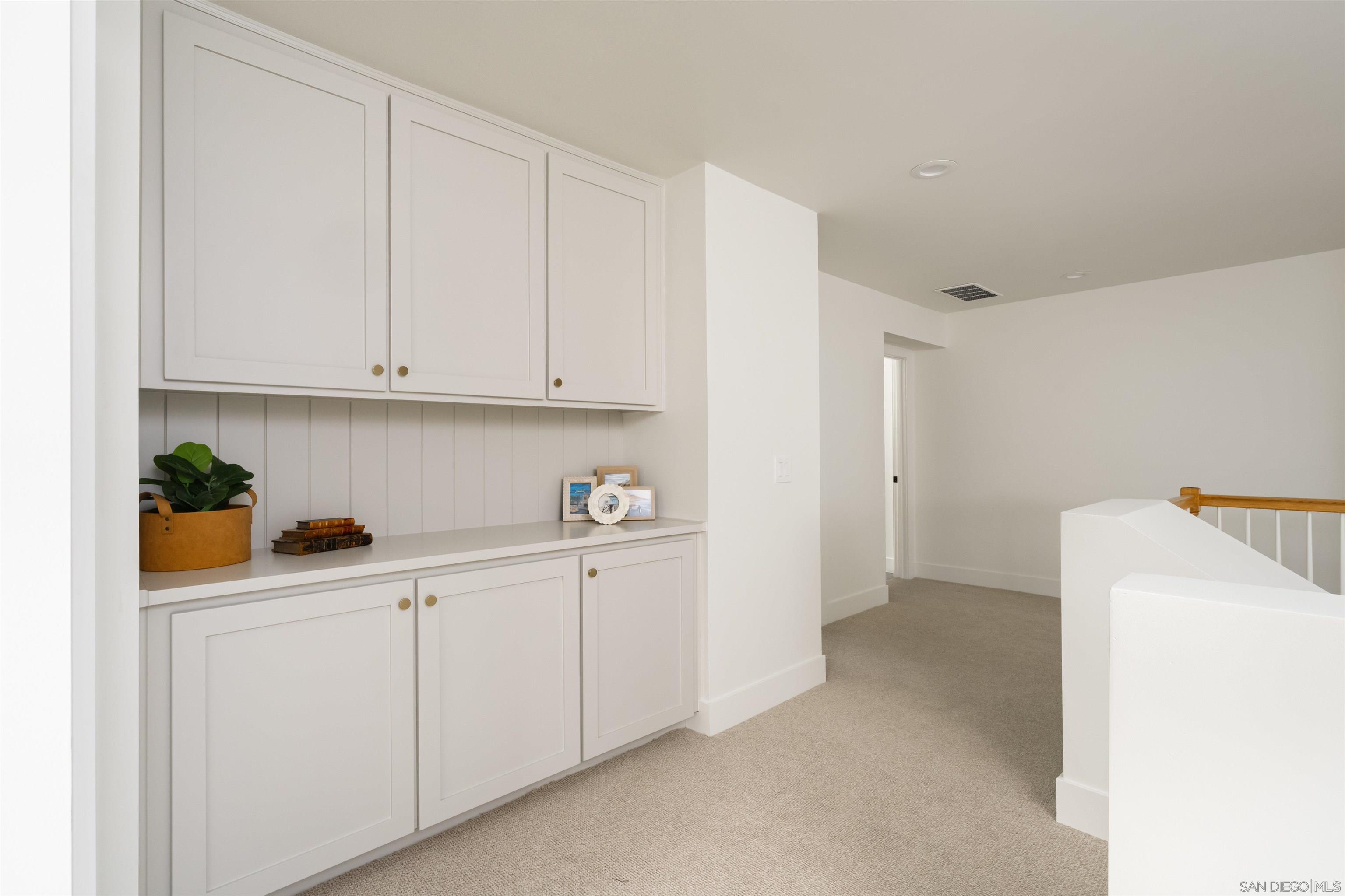 5077 Ashberry Road Carlsbad, CA 92008 - Photo 20 of 35 a utility room with cabinets washer and dryer