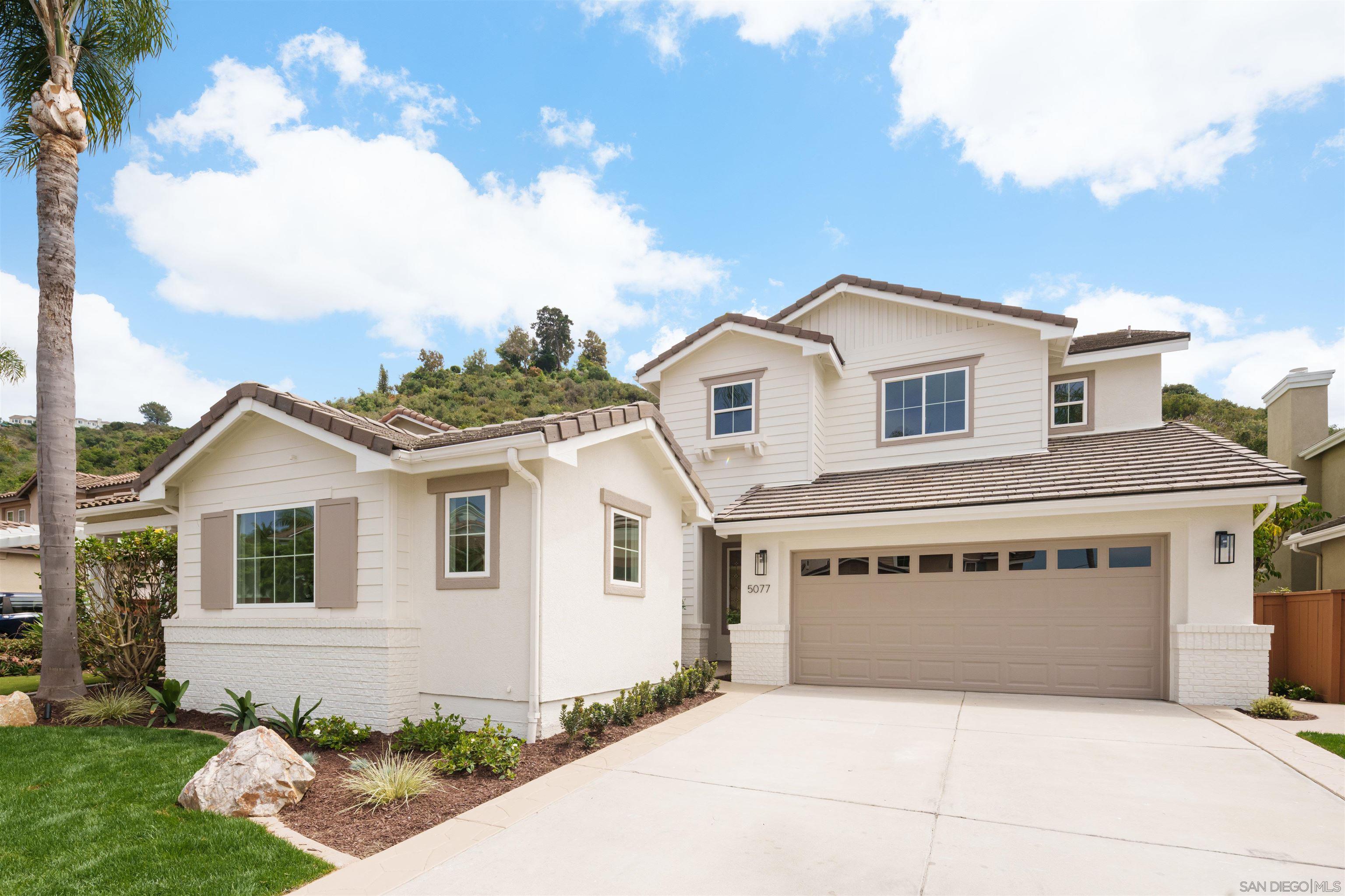5077 Ashberry Road Carlsbad, CA 92008 - Photo 2 of 35 a front view of a house with a garden