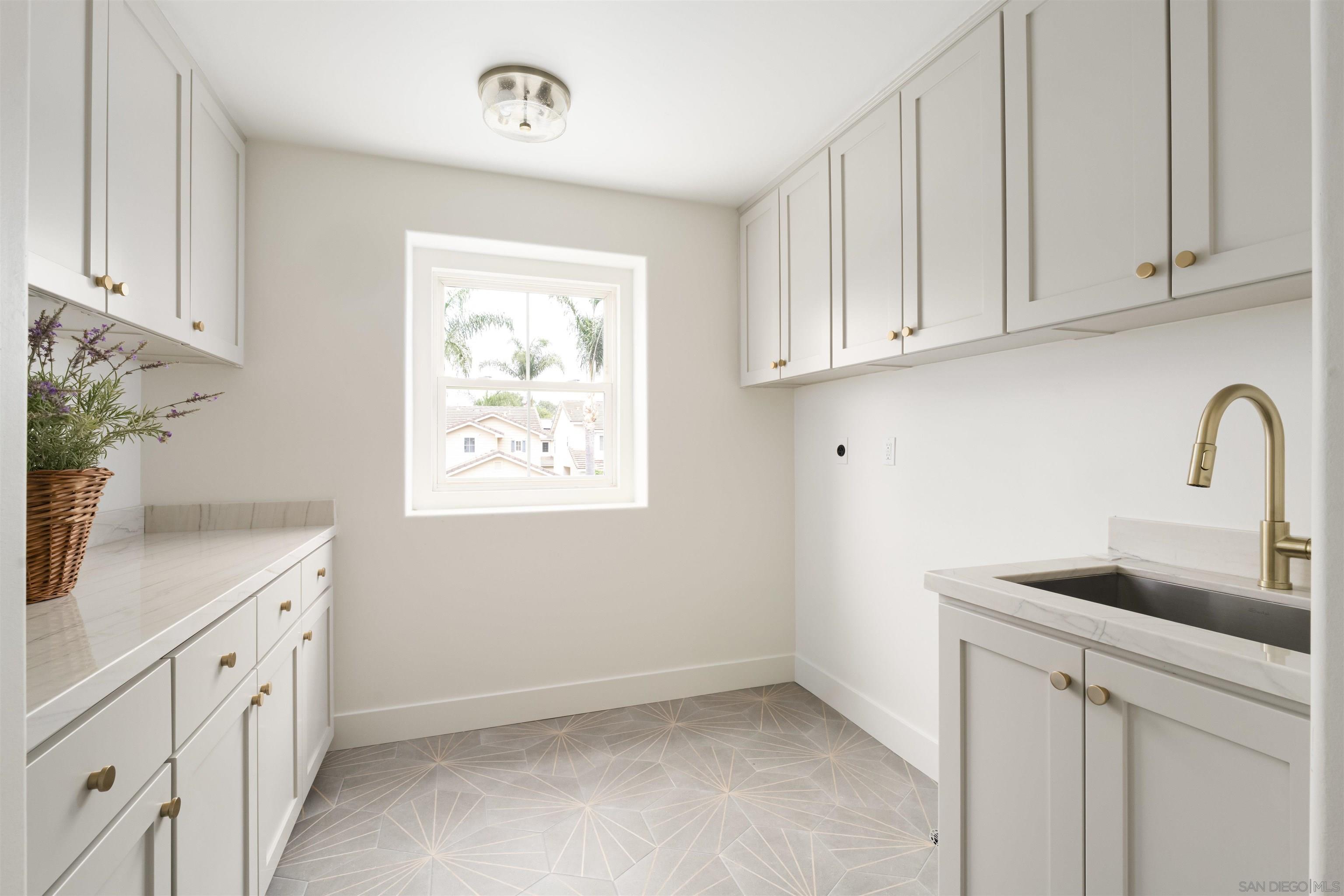 5077 Ashberry Road Carlsbad, CA 92008 - Photo 25 of 35 a kitchen with white cabinets and sink
