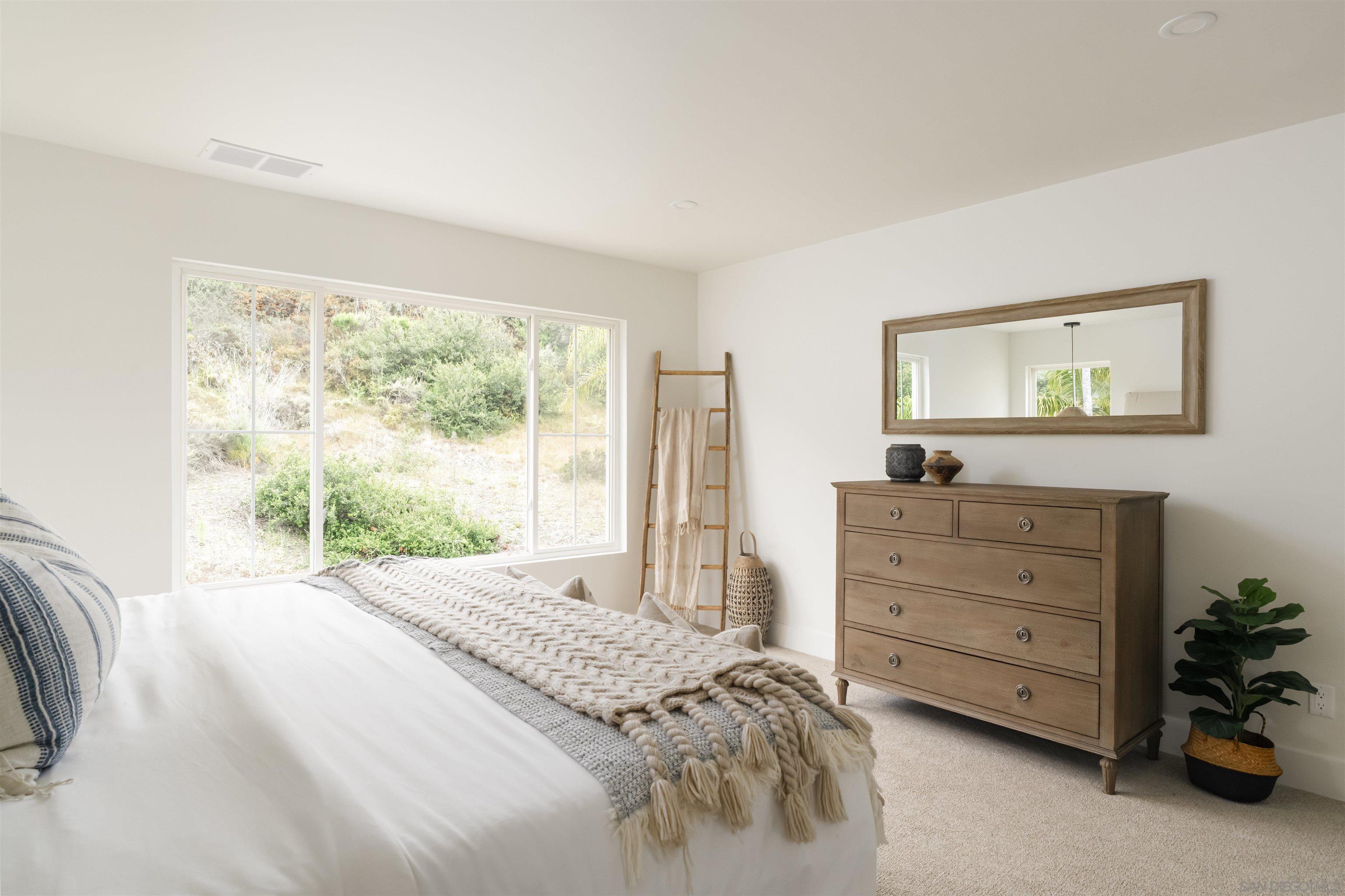 5077 Ashberry Road Carlsbad, CA 92008 - Photo 26 of 35 a bedroom with a bed and a window