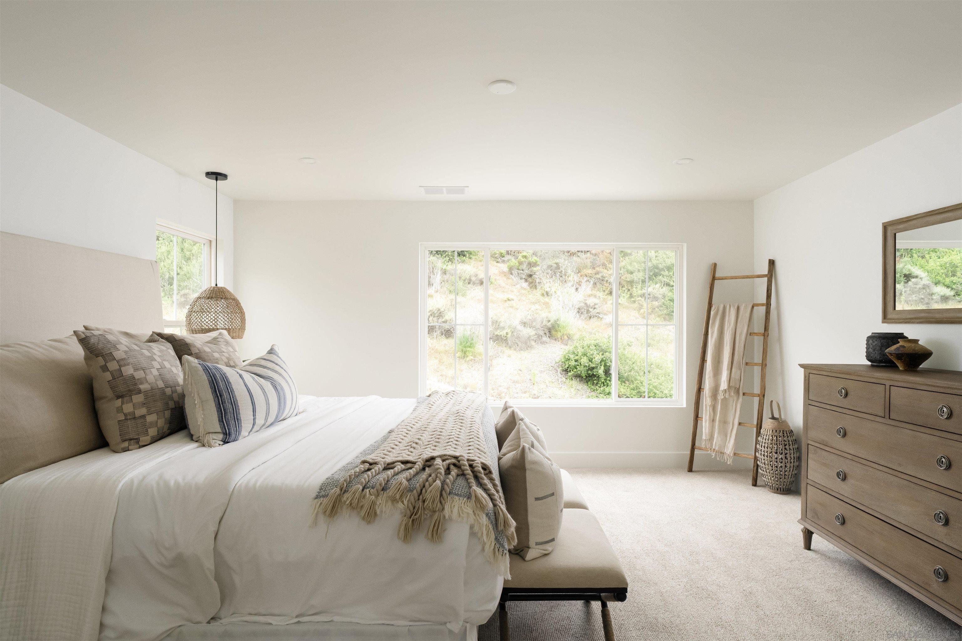 5077 Ashberry Road Carlsbad, CA 92008 - Photo 27 of 35 a bedroom with a bed and a window