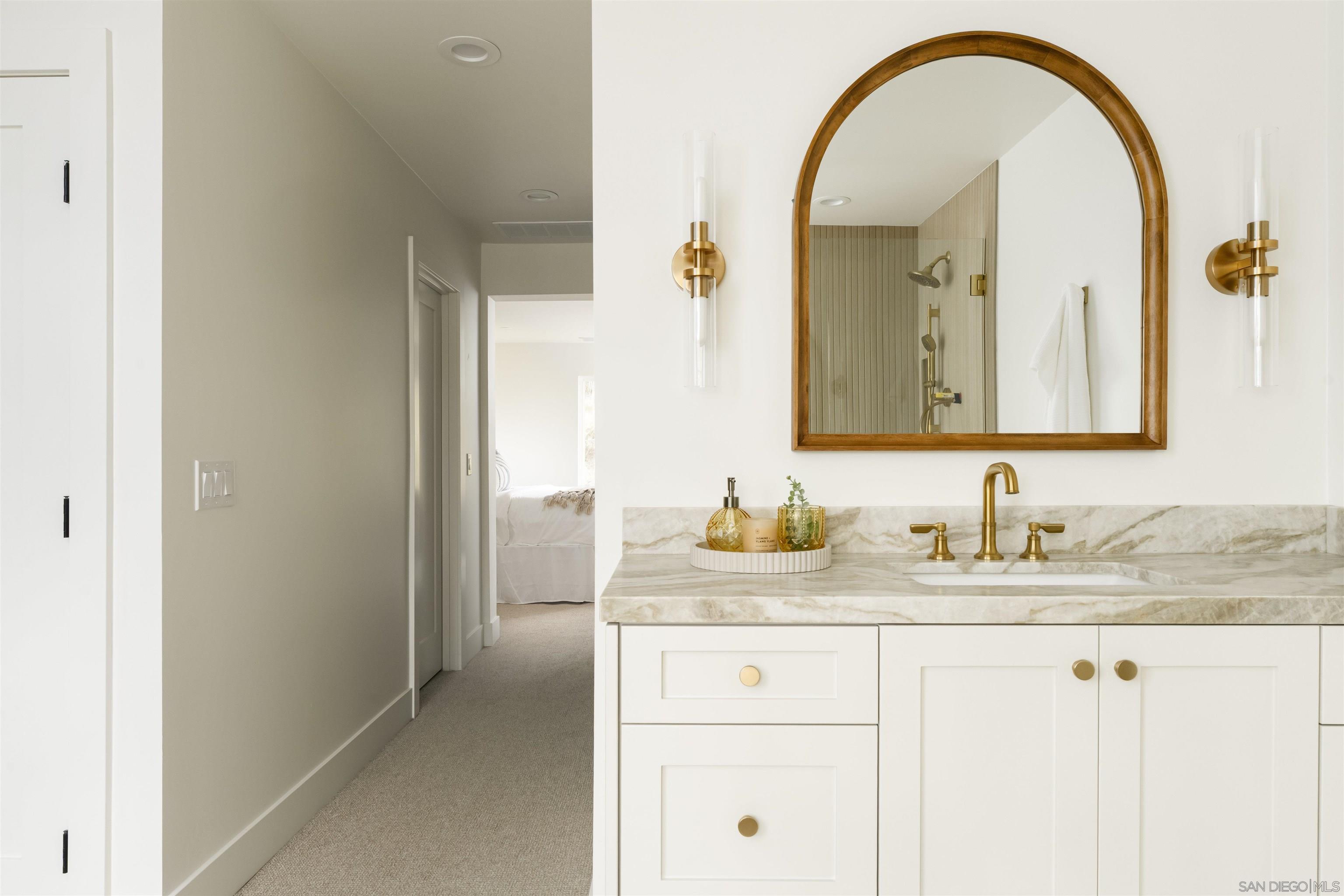 5077 Ashberry Road Carlsbad, CA 92008 - Photo 30 of 35 a bathroom with a granite countertop sink a mirror and a