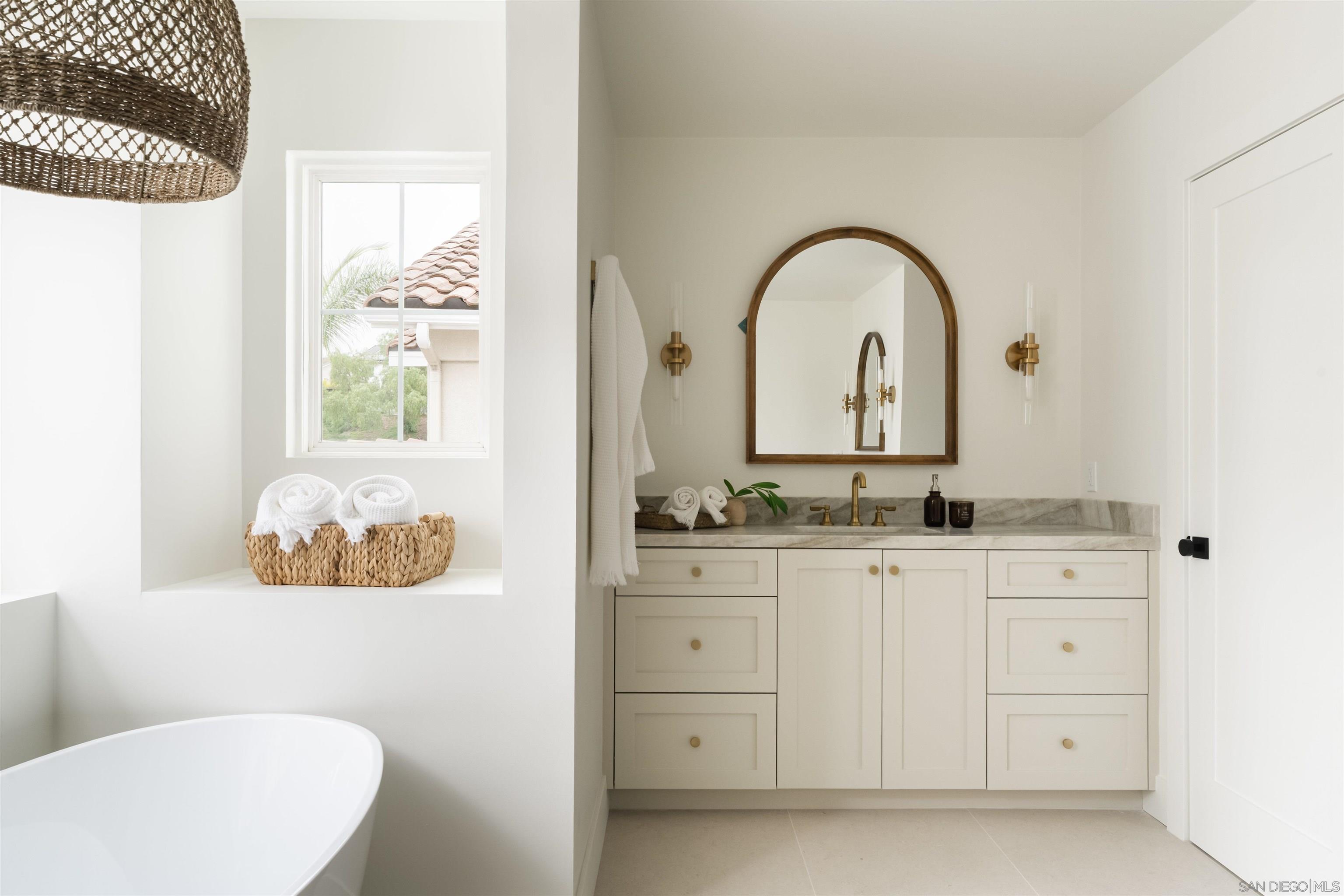 5077 Ashberry Road Carlsbad, CA 92008 - Photo 32 of 35 a bathroom with a double vanity sink and a mirror