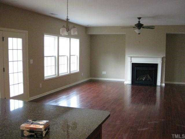 2105 Lower Lake Road Wake Forest, NC 27587 - Photo 4 of 12 Kitchen opens into large family room with a gas fireplace & triple windows + French door for lots of light! Den/Family/Great Room