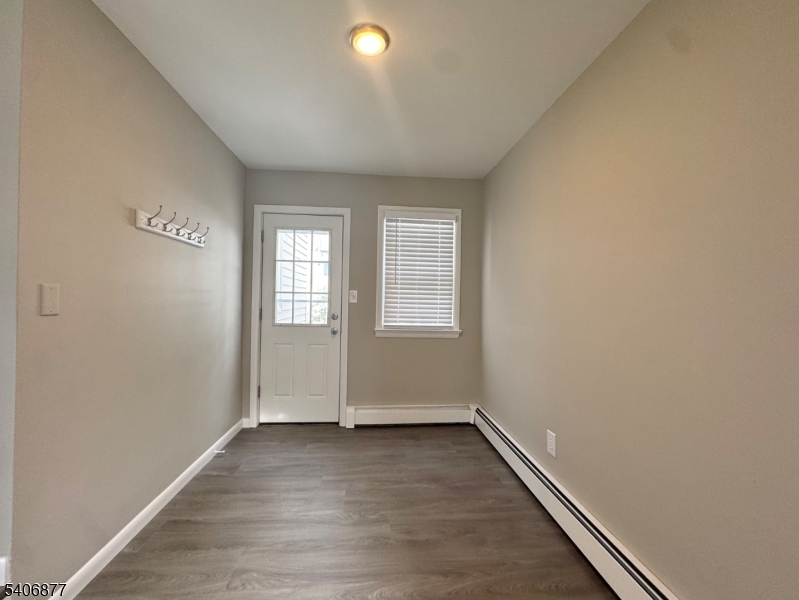 156 East Prospect Street, Unit 1 Hackettstown, NJ 07840 - Photo 14 of 21 an empty room with wooden floor and windows