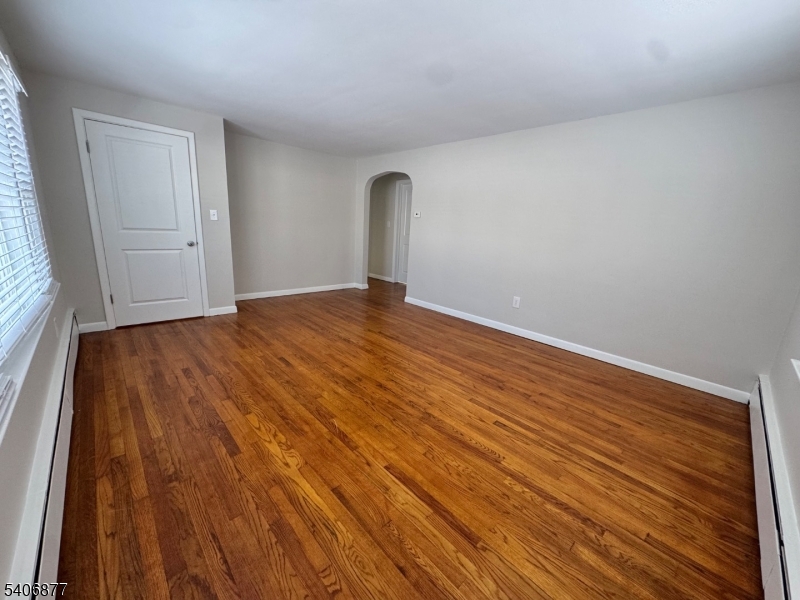 156 East Prospect Street, Unit 1 Hackettstown, NJ 07840 - Photo 3 of 21 a view of empty room with window and wooden floor