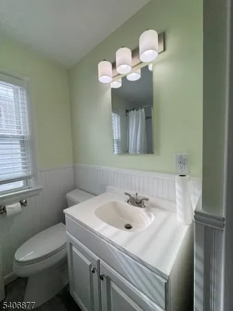 a bathroom with a sink mirror and toilet