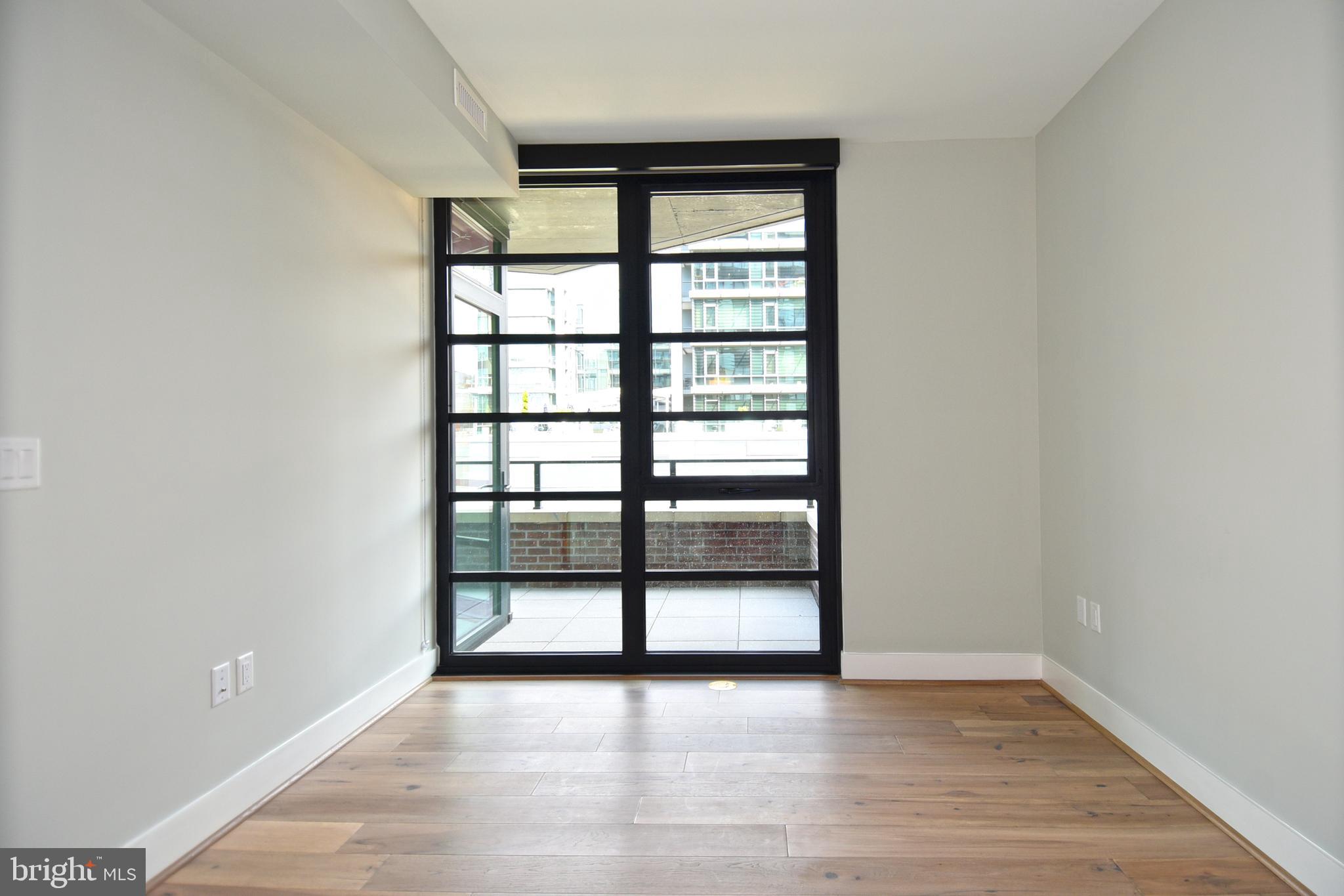 1300 4th Street Southeast, Unit 413 Washington, DC 20003 - Photo 14 of 47 wooden floor in an empty room with a window