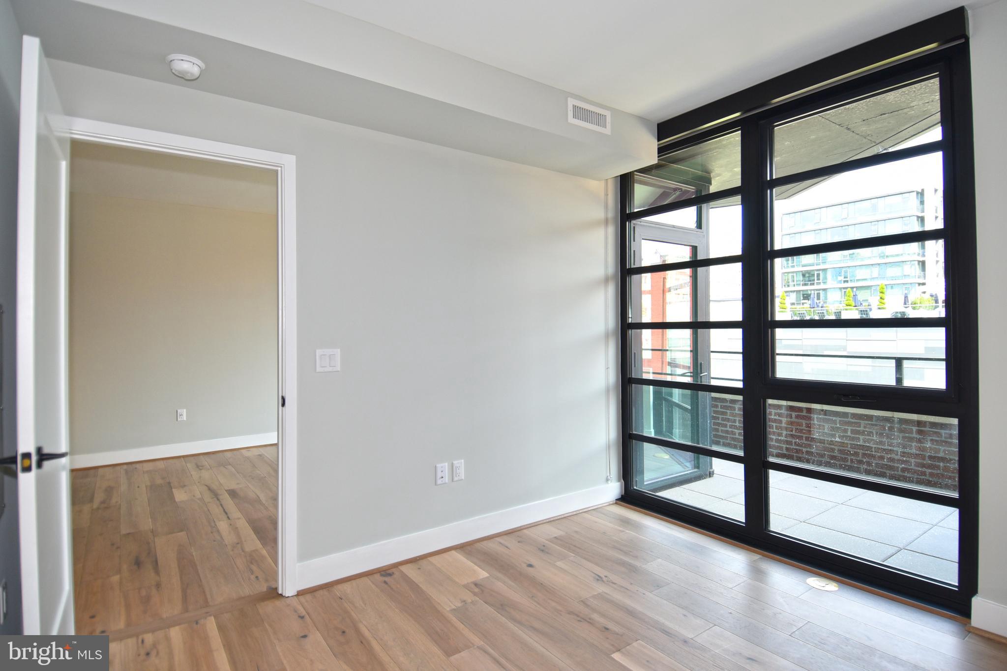 1300 4th Street Southeast, Unit 413 Washington, DC 20003 - Photo 15 of 47 a view of empty room with wooden floor and fan