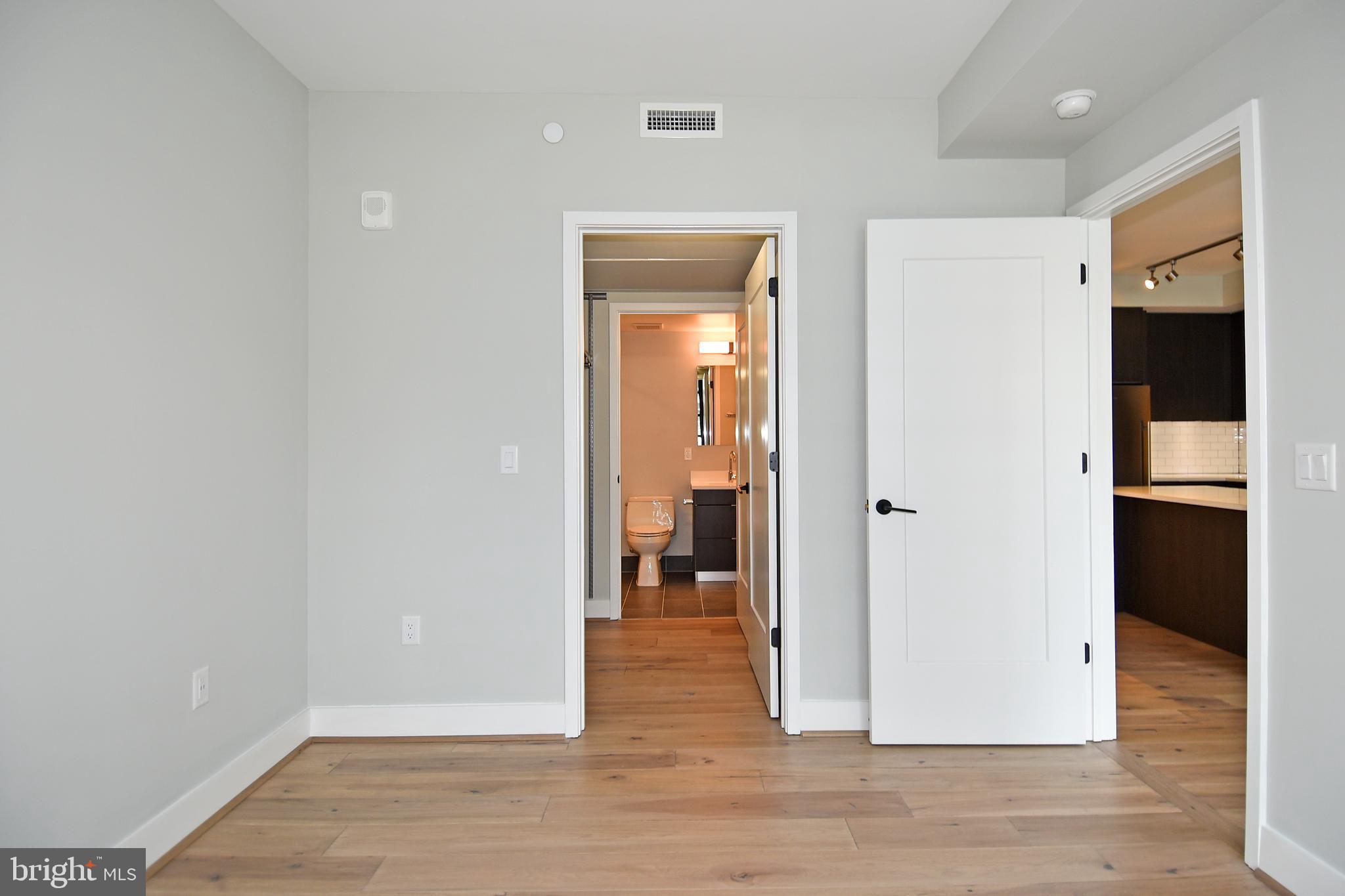 1300 4th Street Southeast, Unit 413 Washington, DC 20003 - Photo 17 of 47 a view of a hallway with wooden floor and closet