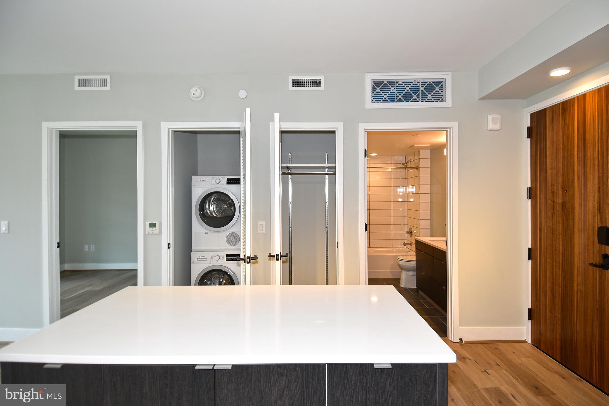 1300 4th Street Southeast, Unit 413 Washington, DC 20003 - Photo 31 of 47 a large bedroom with a bed and wooden floor