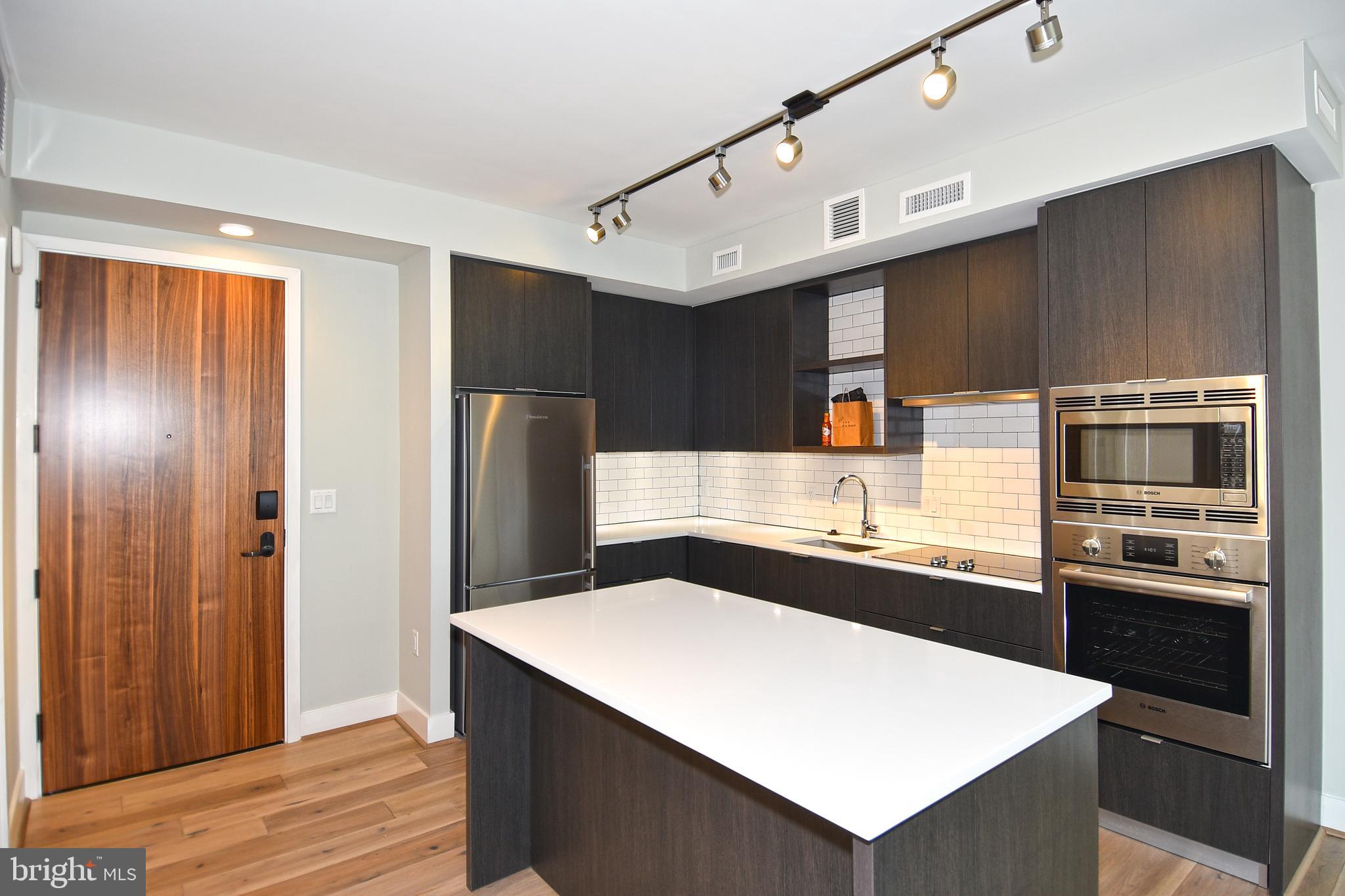 1300 4th Street Southeast, Unit 413 Washington, DC 20003 - Photo 6 of 47 a kitchen with stainless steel appliances a refrigerator and a stove