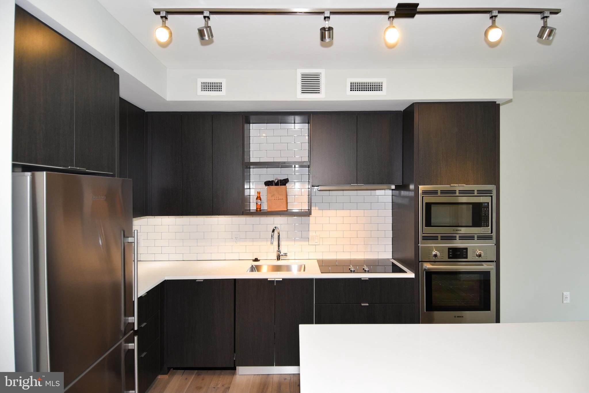 1300 4th Street Southeast, Unit 413 Washington, DC 20003 - Photo 8 of 47 a kitchen with a refrigerator and a sink