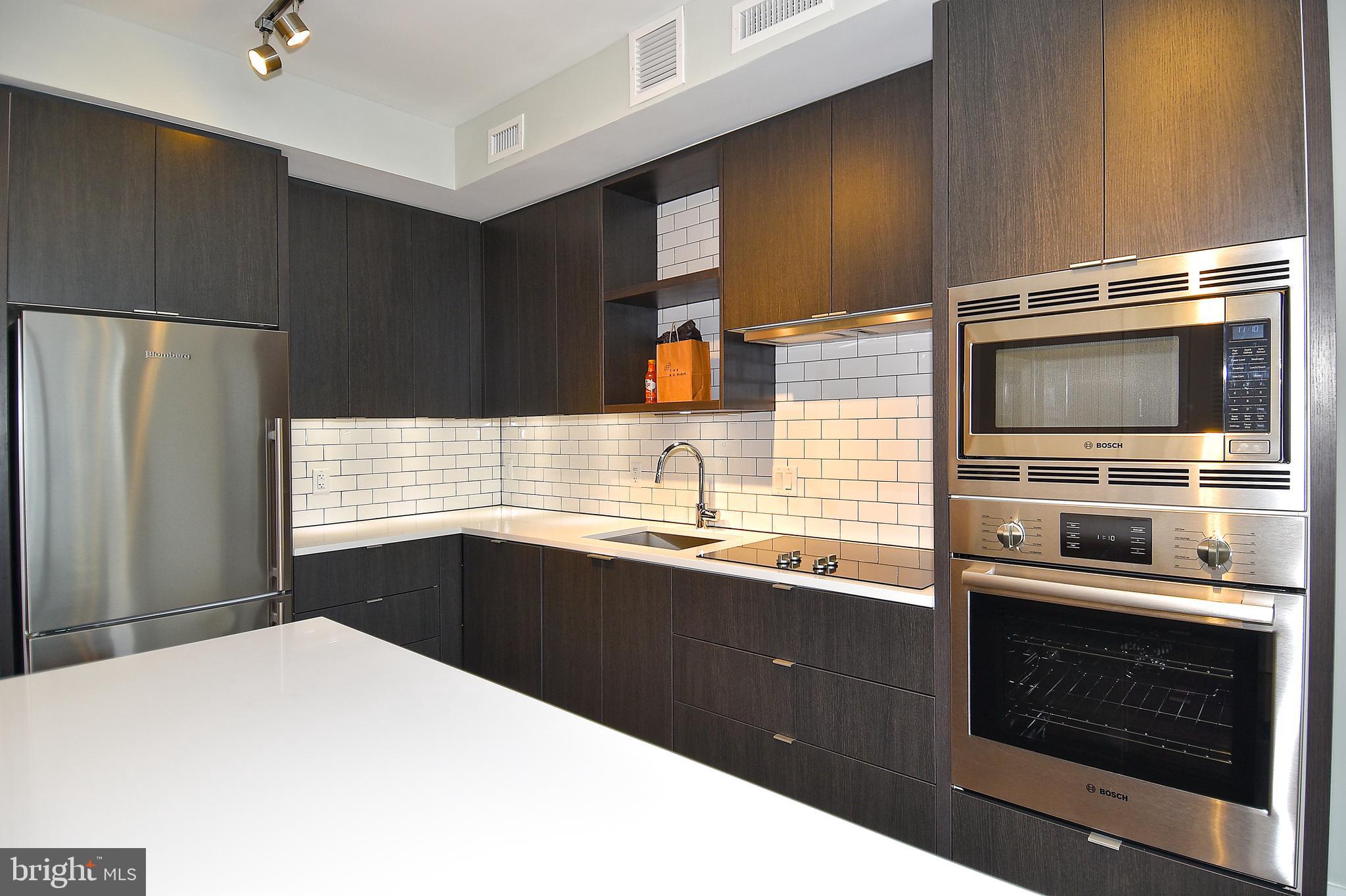 1300 4th Street Southeast, Unit 413 Washington, DC 20003 - Photo 10 of 47 a kitchen with stainless steel appliances a stove sink and refrigerator