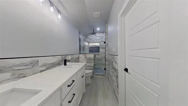 an empty room with a window and a ceiling fan