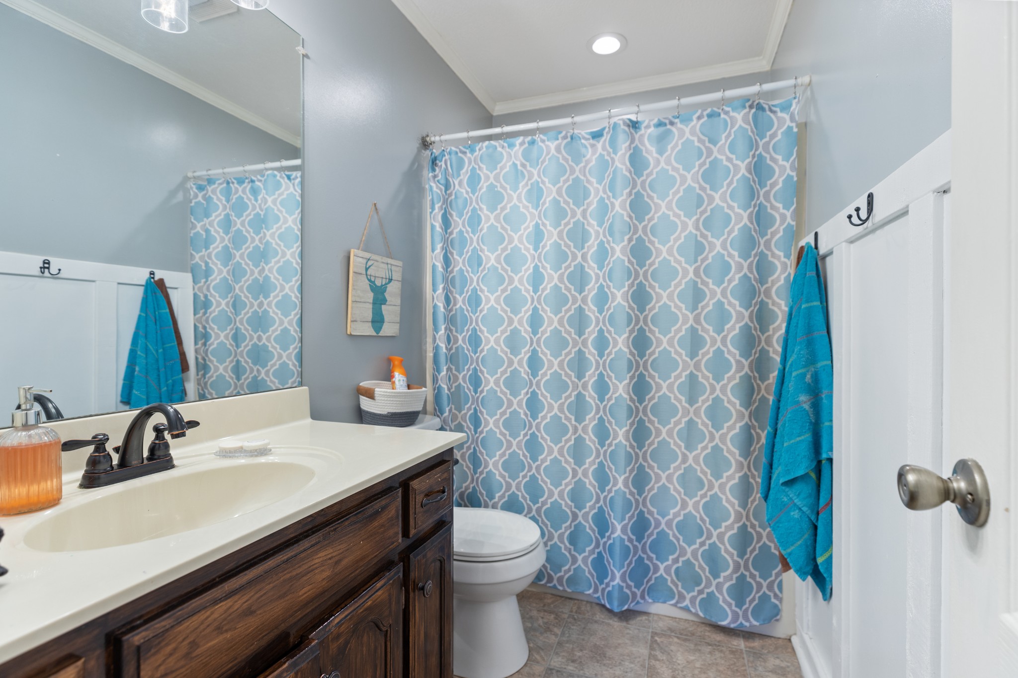125 Oak Crest Drive Tennessee Ridge, TN 37178 - Photo 11 of 31 a bathroom with a sink a toilet and shower curtain