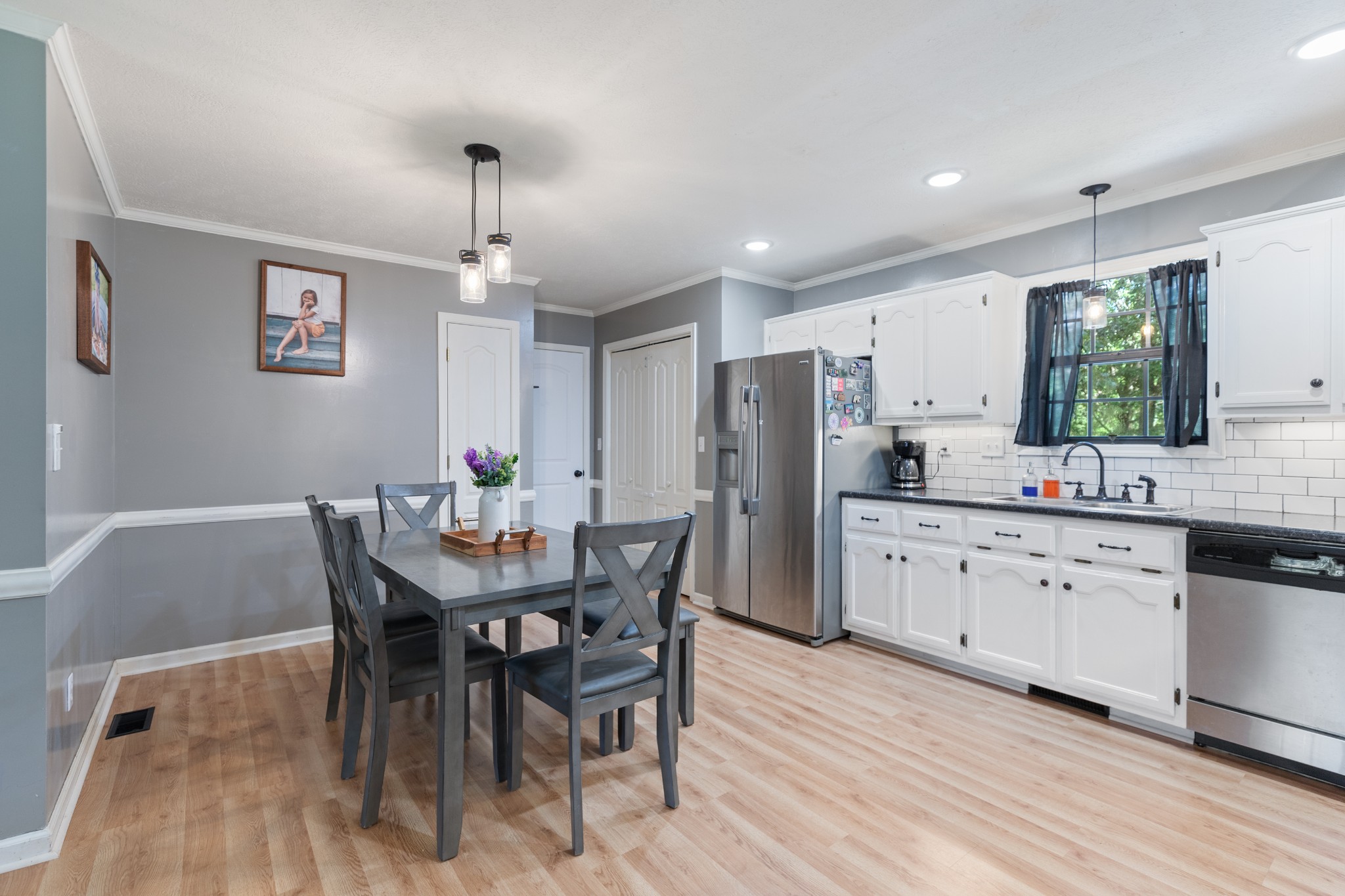 125 Oak Crest Drive Tennessee Ridge, TN 37178 - Photo 12 of 31 a kitchen with stainless steel appliances kitchen island granite countertop a dining table chairs and a refrigerator