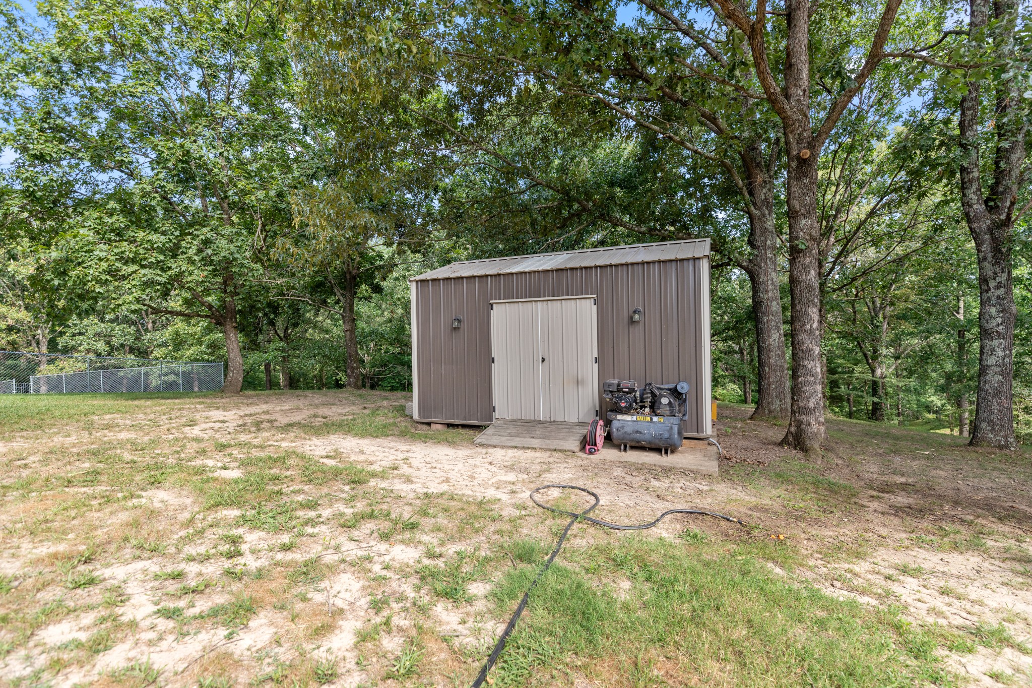 125 Oak Crest Drive Tennessee Ridge, TN 37178 - Photo 25 of 31 a backyard of a house with yard and tree