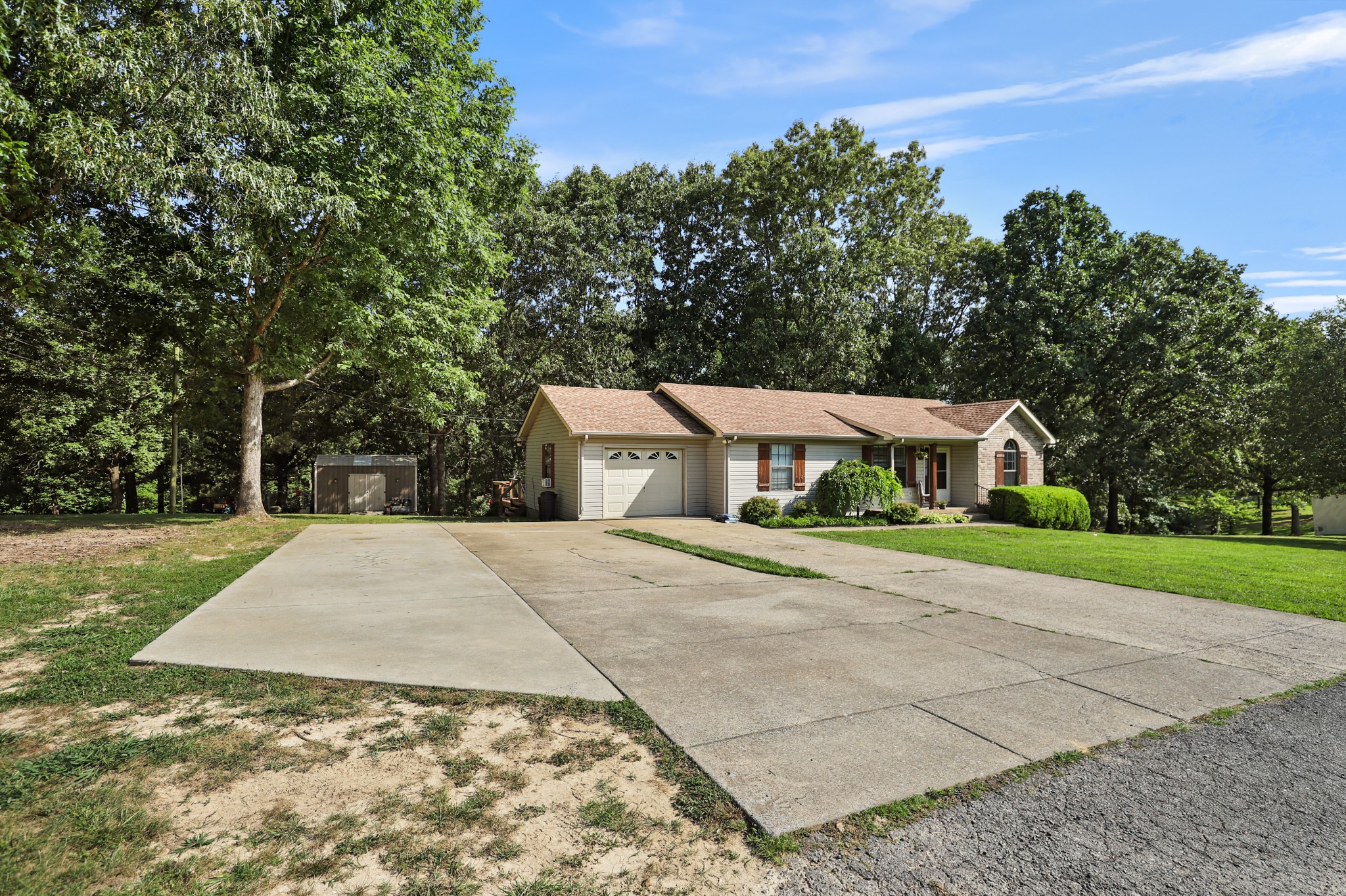 125 Oak Crest Drive Tennessee Ridge, TN 37178 - Photo 3 of 31 a front view of a house with a yard and trees
