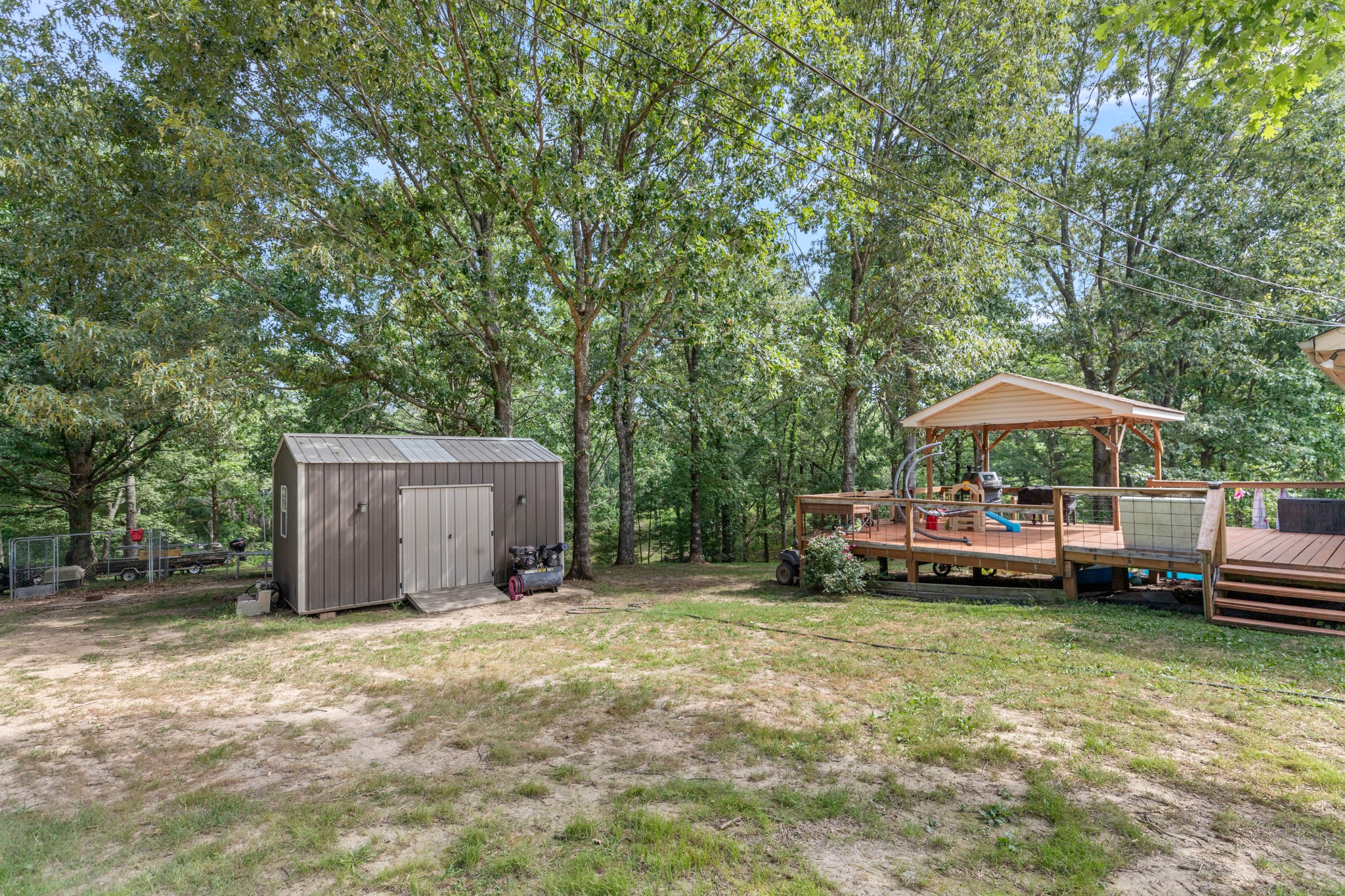 125 Oak Crest Drive Tennessee Ridge, TN 37178 - Photo 31 of 31 a backyard of a house with barbeque oven table and chairs