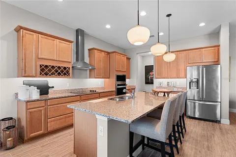 a kitchen with cabinets appliances and a dining table