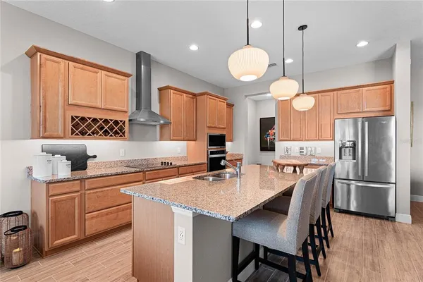 a kitchen with cabinets appliances and a dining table