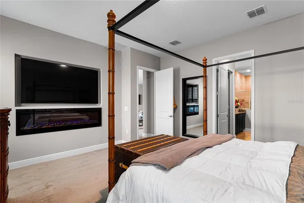a bedroom with a bed and a television in it