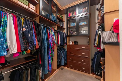 a bathroom with a granite countertop sink a large mirror and a shower