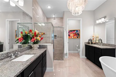 a spacious bathroom with a granite countertop sink a toilet and a bathtub