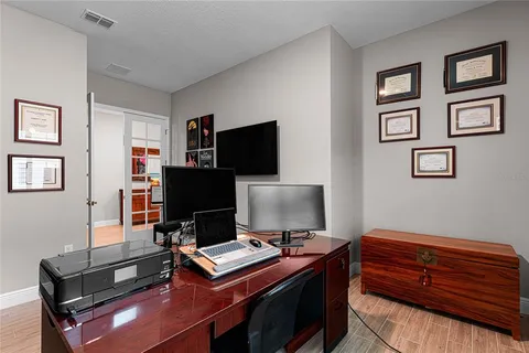 a room with gym equipment and flat screen tv