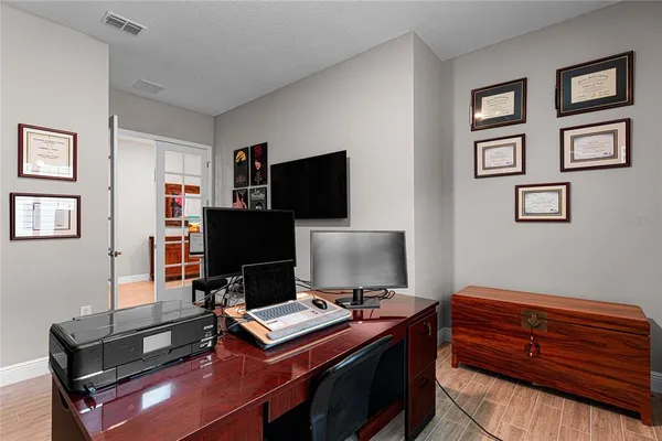 a room with gym equipment and flat screen tv