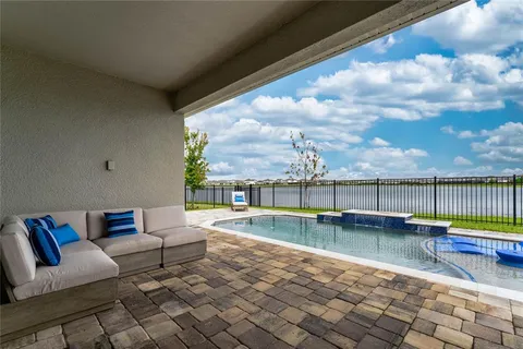 a living room with furniture and a floor to ceiling window