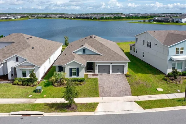 an aerial view of a house with garden space and lake view