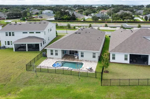an aerial view of a house with a big yard