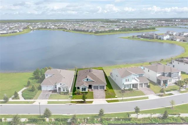 an aerial view of residential houses with outdoor space and swimming pool