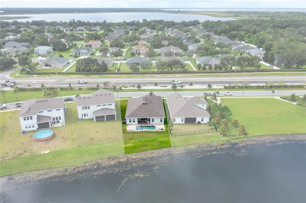 an aerial view of residential houses with outdoor space and swimming pool