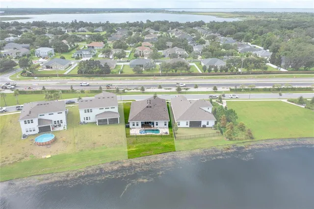 an aerial view of residential houses with outdoor space and swimming pool