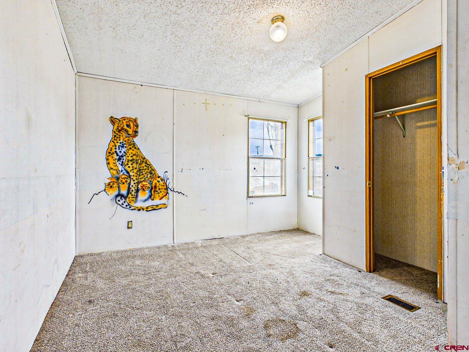 15484 Peach Road Cedaredge, CO 81413 - Photo 17 of 35 an empty room with windows and cabinet