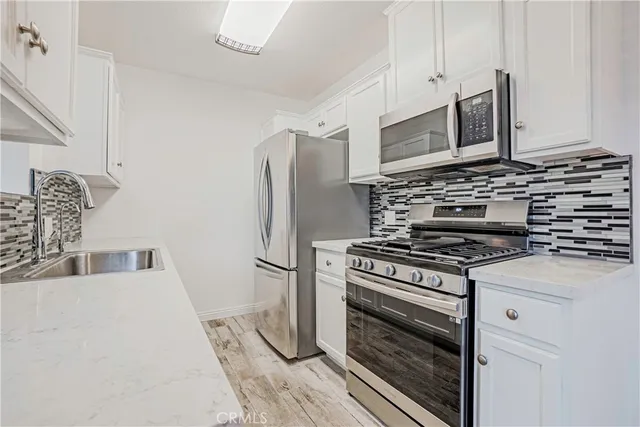 a kitchen with a stove and a refrigerator