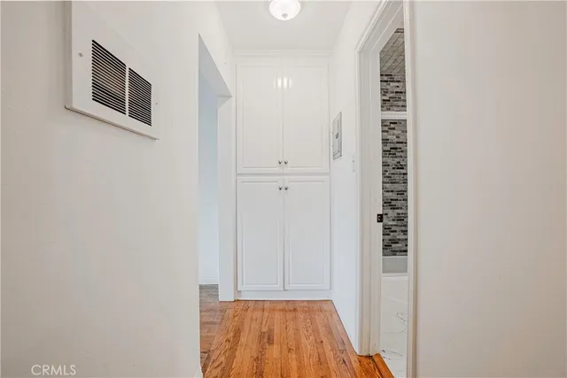 a view of a hallway with wooden floor and entryway