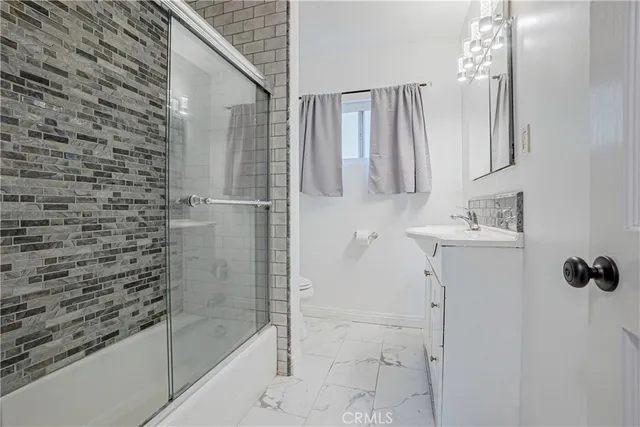 a bathroom with a shower and a sink