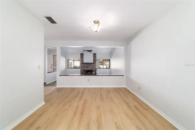 a view of kitchen and hall with wooden floor