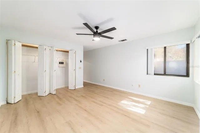 a view of a livingroom with a ceiling fan and window