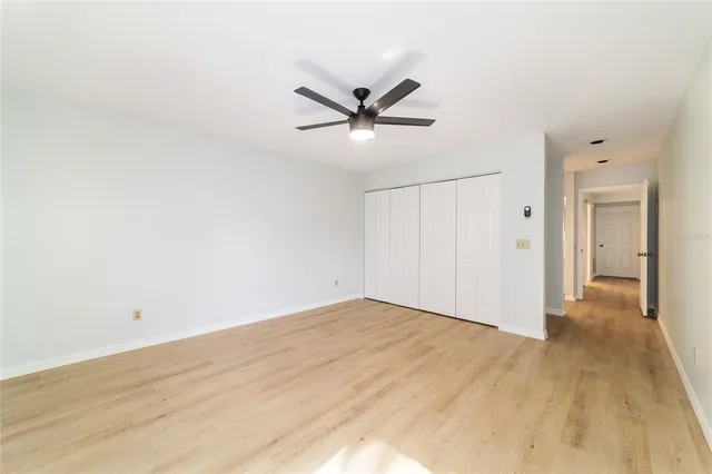 a view of a livingroom with a ceiling fan and window