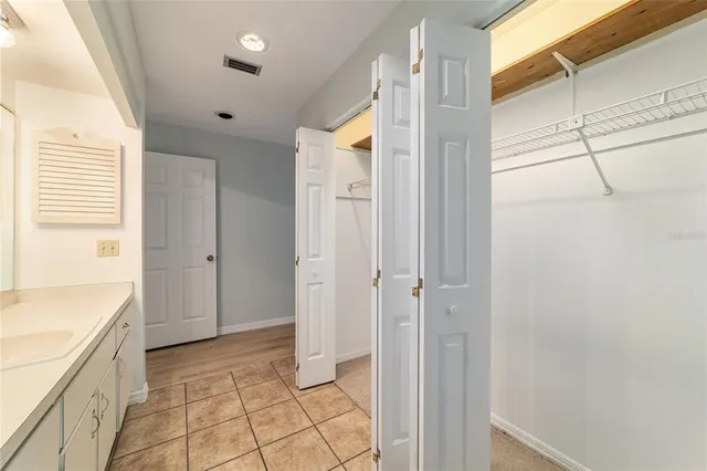 a bathroom with a granite countertop sink a mirror and a shower