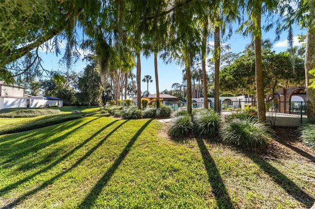 a view of a house with a yard and a fountain